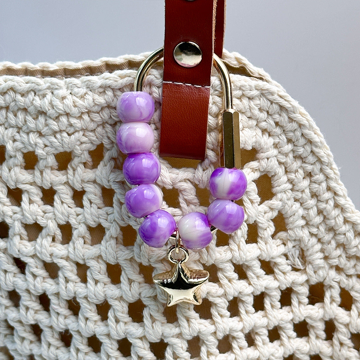 Beaded bag charm on handbag